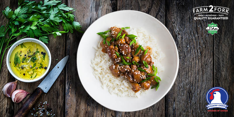 Plated sesame chicken beautifully garnished with coriander served with rice | Country Choice Chicken breast