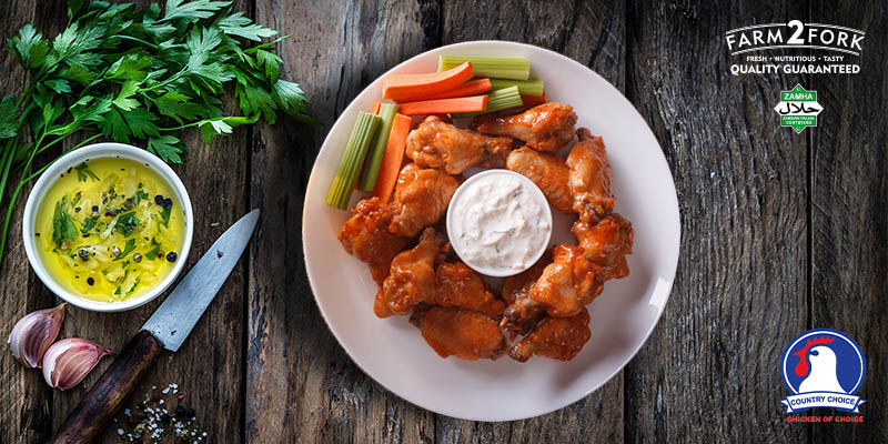 Plated buffalo chicken wings served with sauce, celery and carrots | Country Choice Chicken Wings