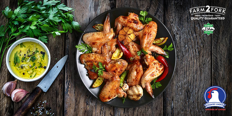 Plated spicy chicken wings with potato wedges garnished with coriander | Country Choice Chicken Wings