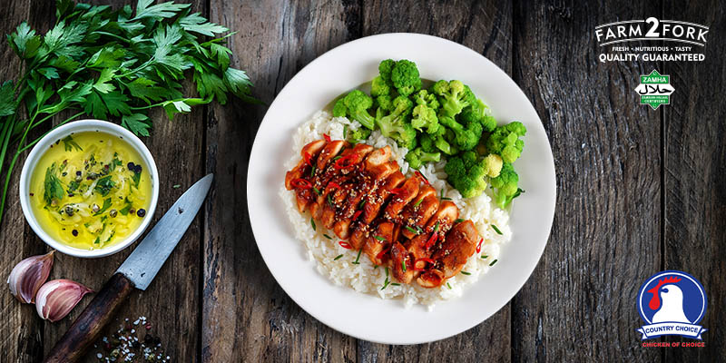 Plated strips of honey garlic chicken thighs served with rice and broccoli | Country Choice Chicken thighs